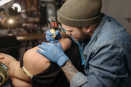 Tattoo Artist Tattooing a Client