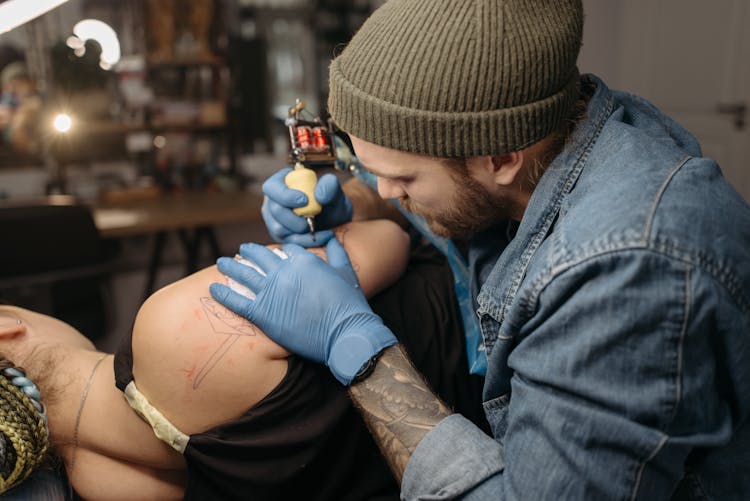 Tattoo Artist Tattooing A Client