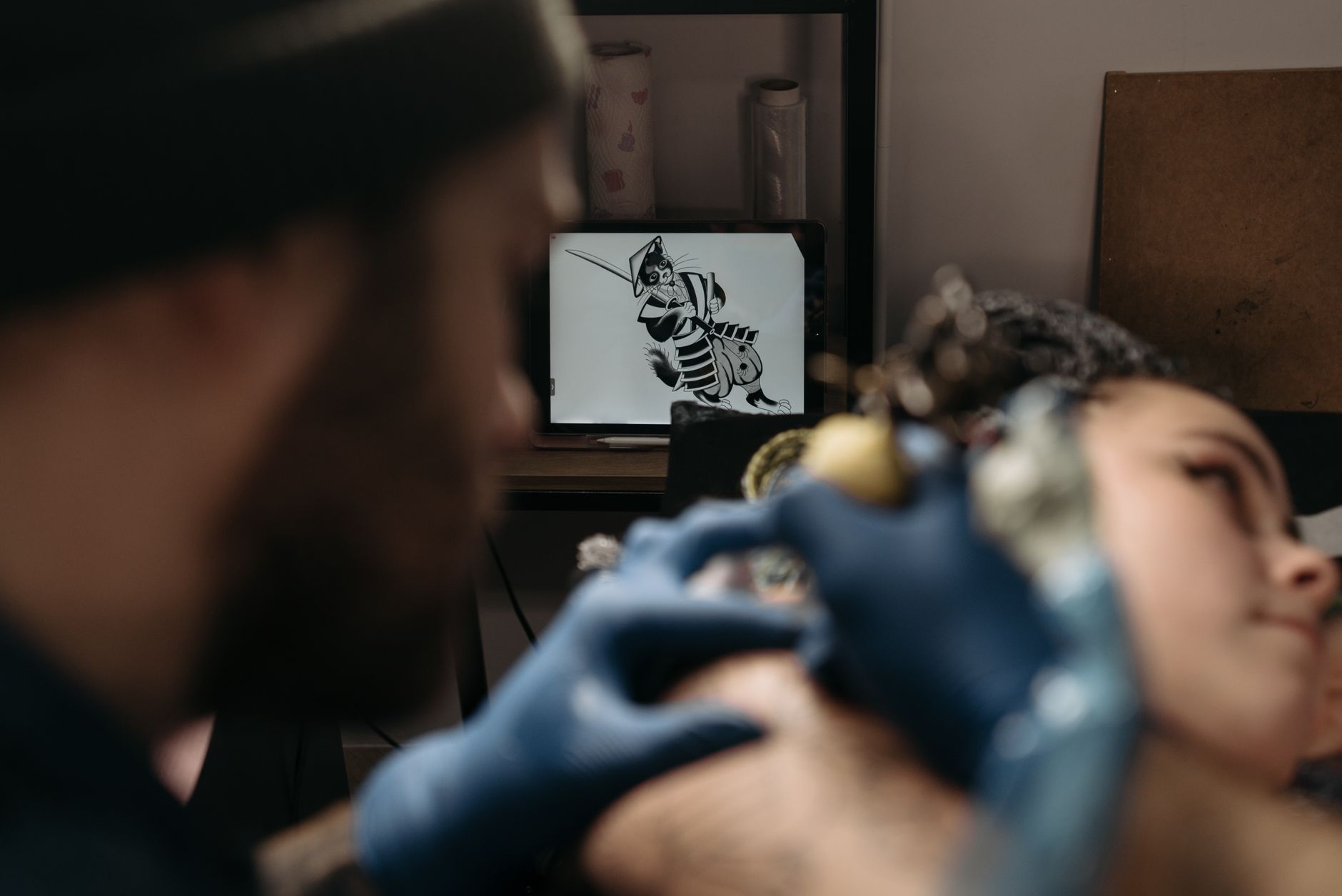 Close-up Shot of an Artist Tattooing a Client