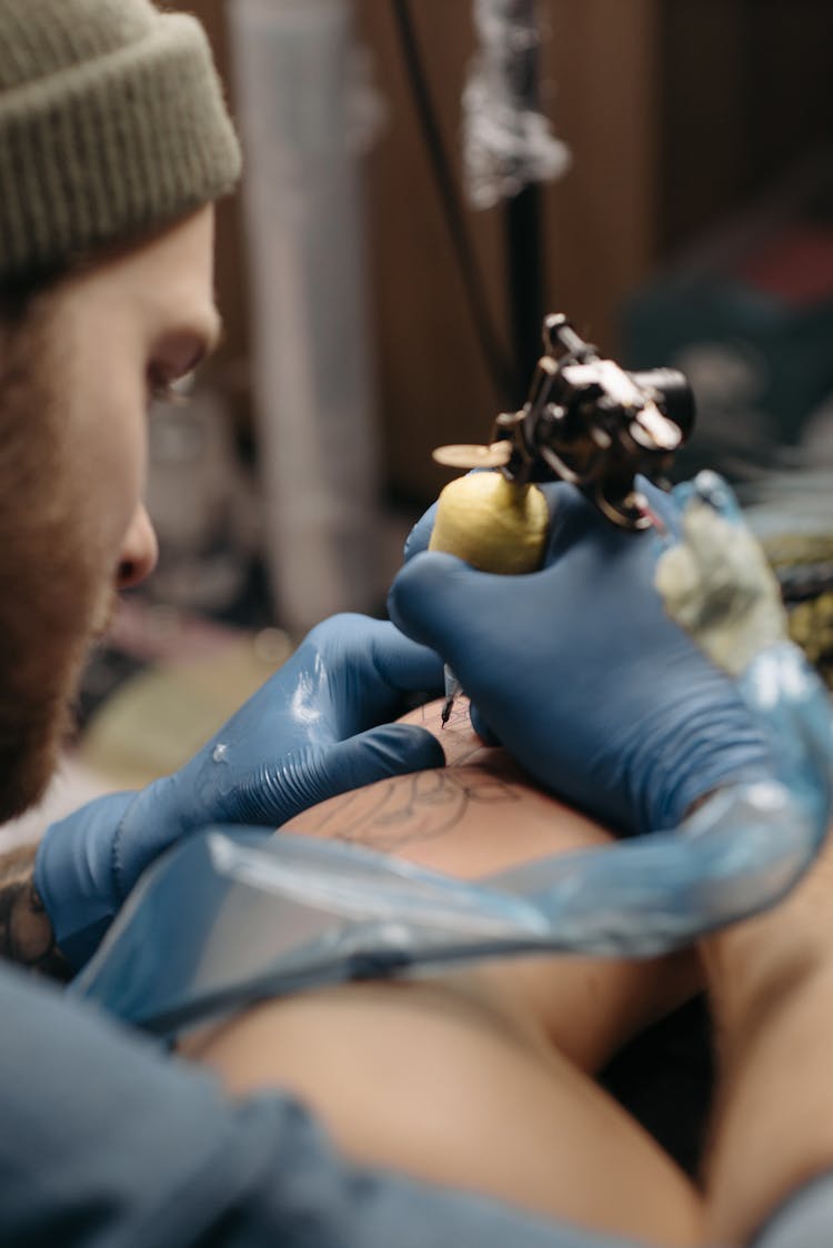 Man Tattooing A Client