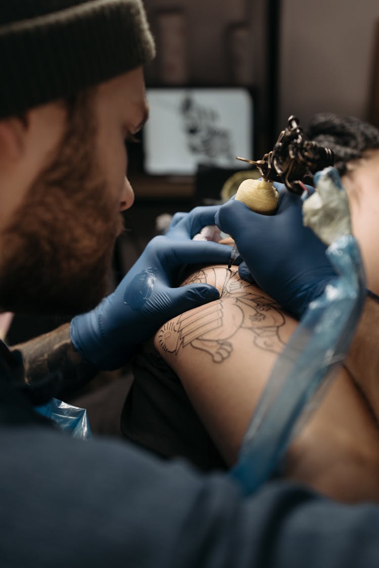 Tattoo Artist Tattooing A Client