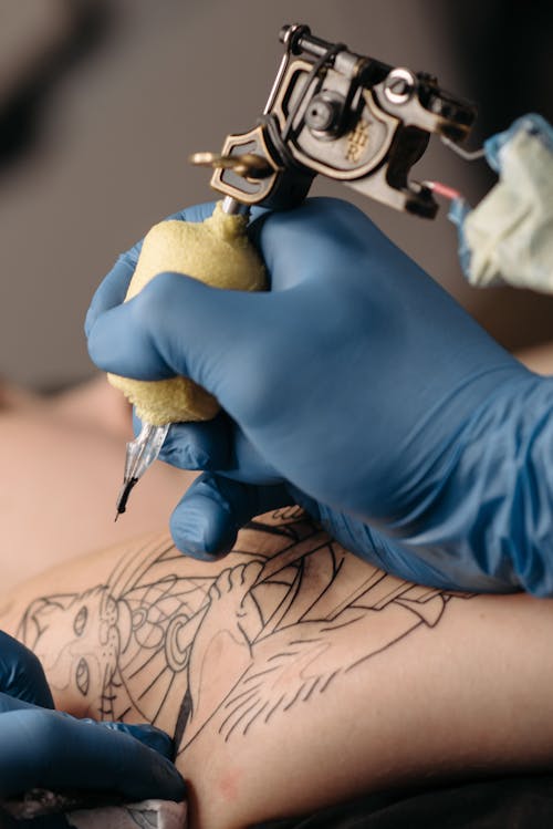 A Hand Holding a Tattoo Machine