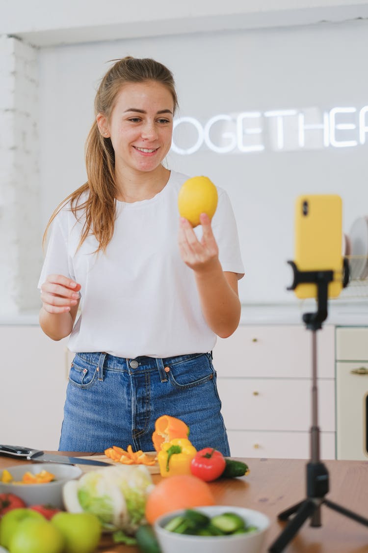 Smiling Woman Filming Food Vlog On Smartphone 