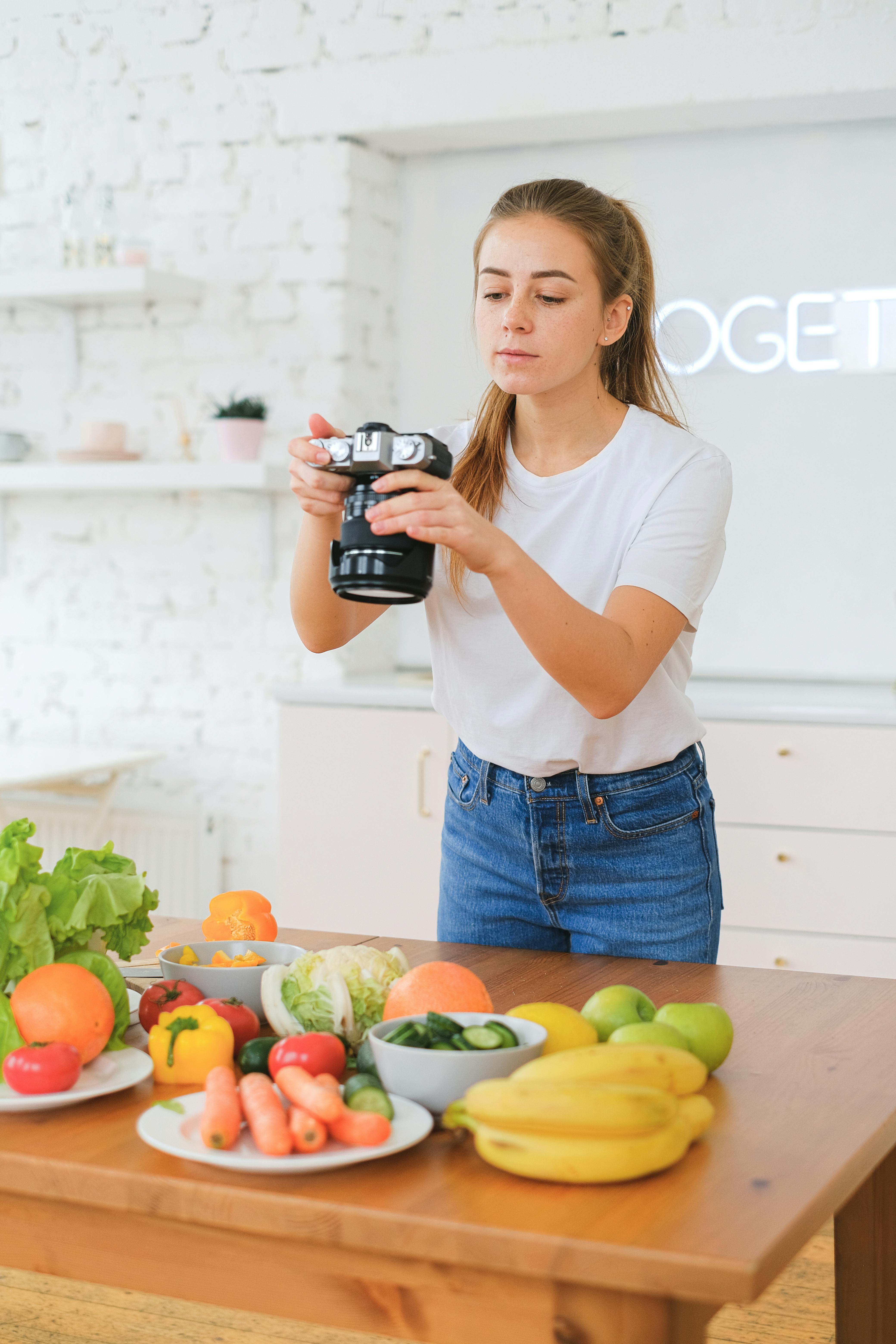 woman taking photo of food on table