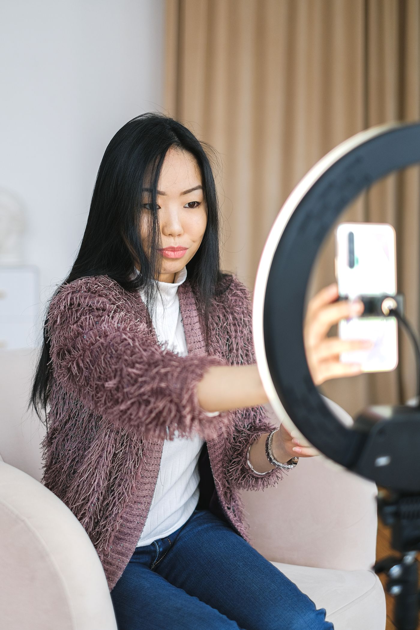 UGC creator using a smartphone and ring light in a home content setup