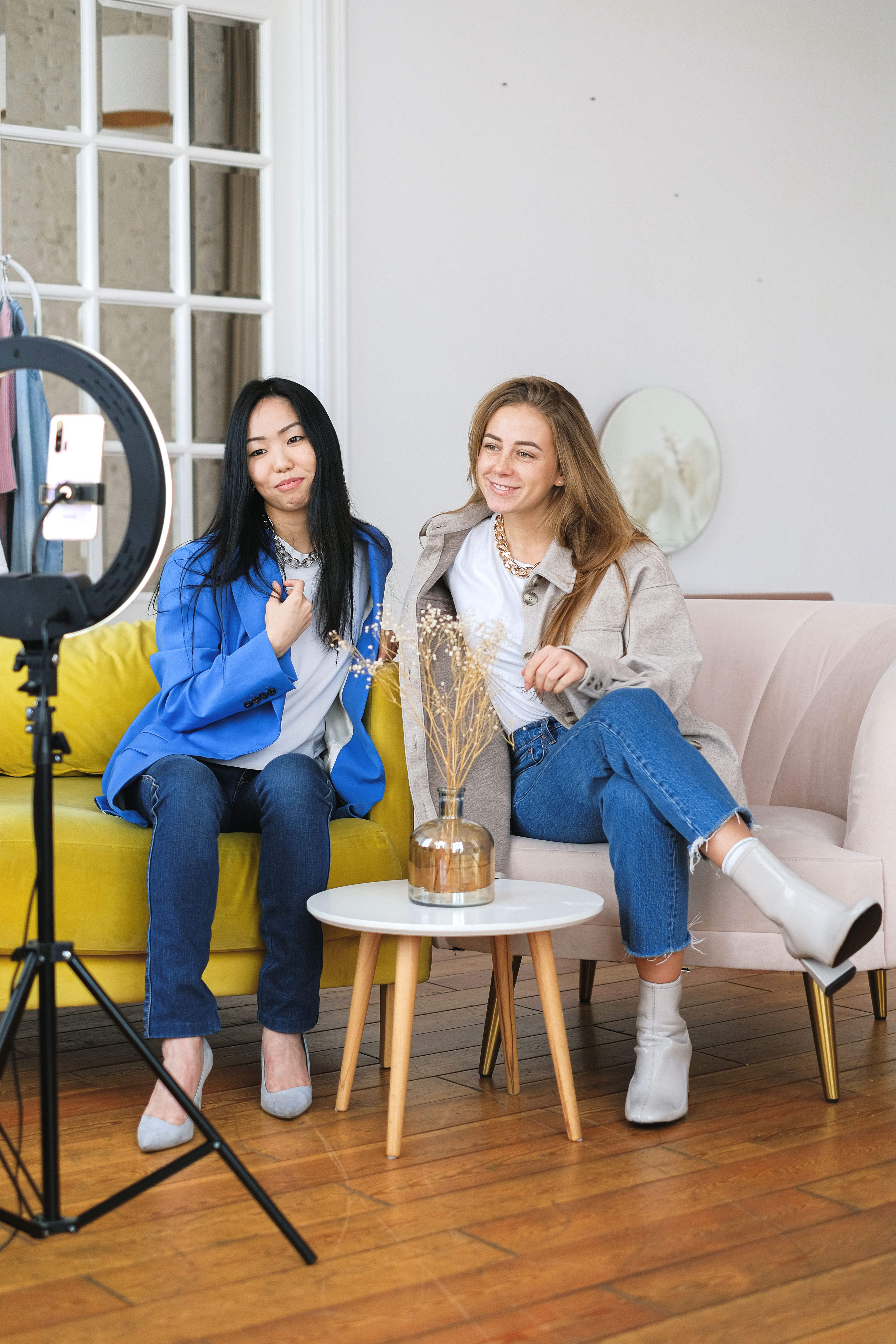 Two people sitting together and filming a podcast.
