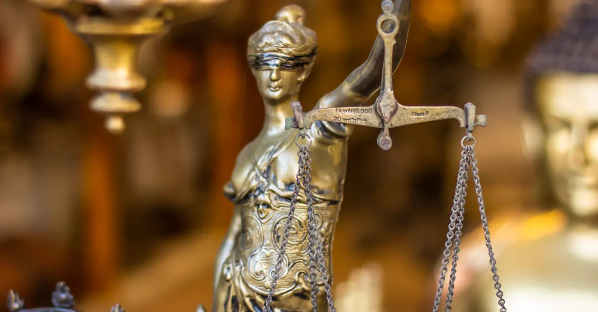 Close-up of a Lady Justice statue holding balanced scales