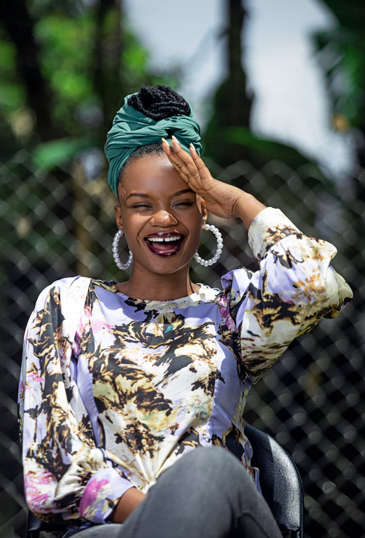 Laughing African American Woman In Turban With Big Earrings