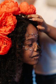 Side profile of a girl with Day of the Dead makeup and vibrant floral headdress.