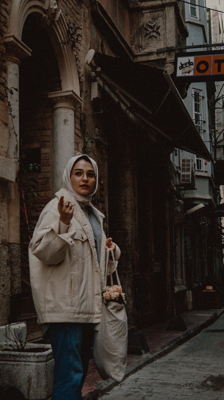 Woman Holding A Shopping Bag Standing On A Street