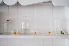 Glass vessels on a white shelf — photo by Anna Tarazevich on Pexels
