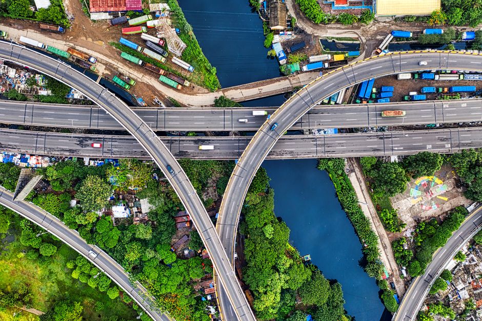 Aerial shot of highway interchanges in Jakarta, showcasing urban landscape and greenery.