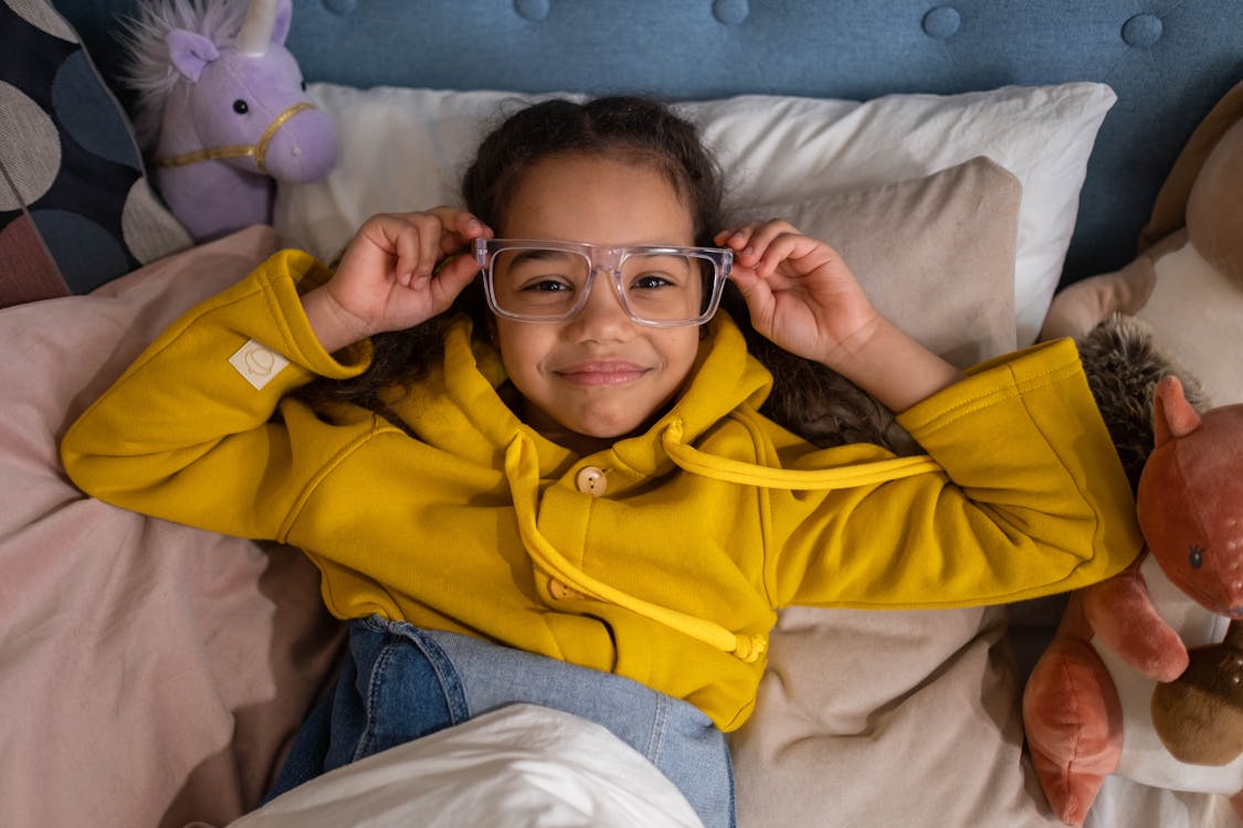 A Girl Wearing a Yellow Hoodie Lying Down