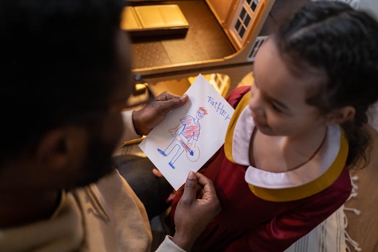 A Girls Showing Dad Her Drawing