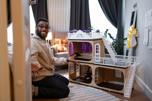 A Father Assembling a Doll House