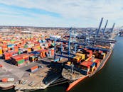 Tanker ship unloading containers in port