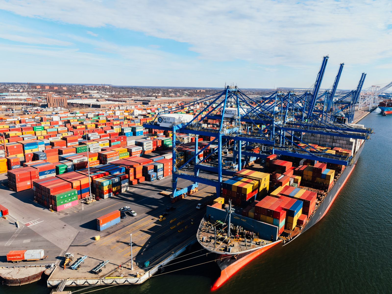 Aerial view of a U.S. shipping port with cranes and colorful cargo containers