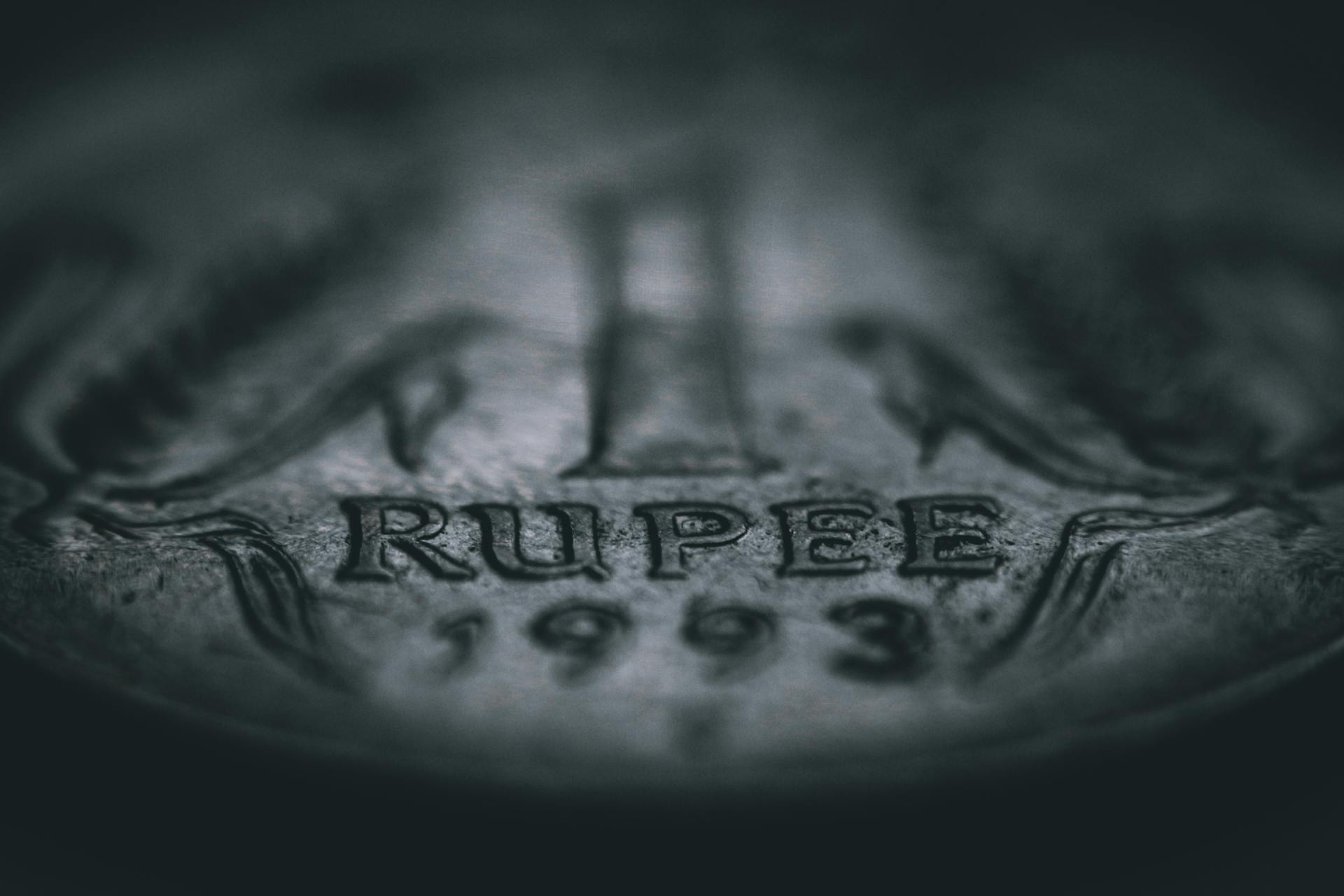 Detailed macro photograph showcasing the texture and engravings of a 1993 rupee coin.