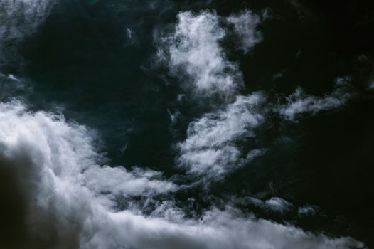 Dark sky contrast with bright white clouds creating a moody atmosphere.