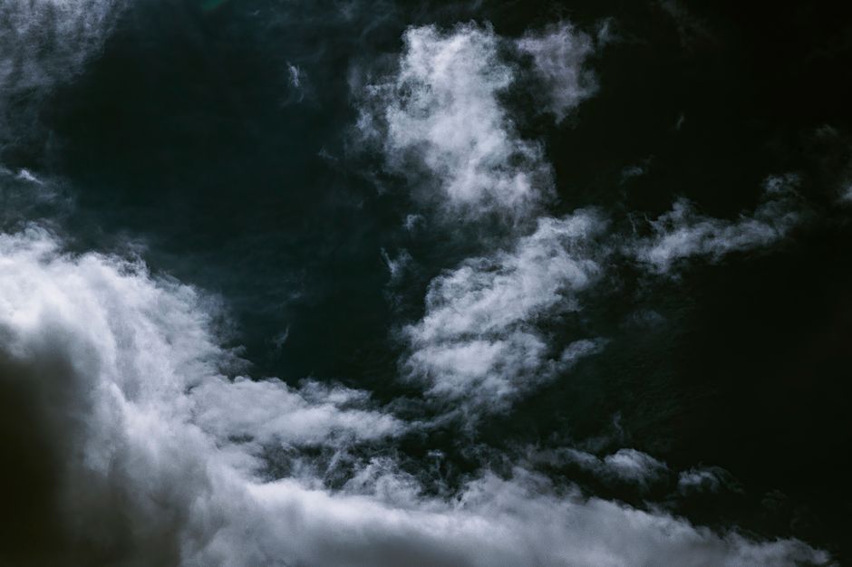 Dark sky contrast with bright white clouds creating a moody atmosphere.