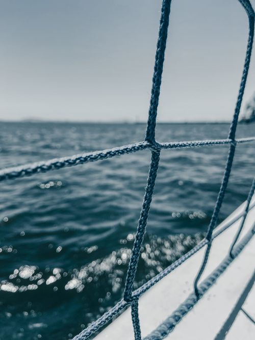 Free Close-up of sailboat rope with ocean view, capturing movement and tranquility. Stock Photo