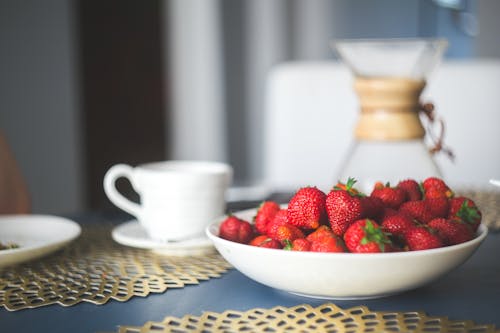 Fresh organic strawberry in white bowl