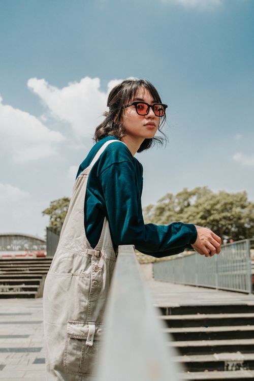 Free Fashionable young woman in sunglasses posing outdoors in Jakarta on a sunny day. Stock Photo