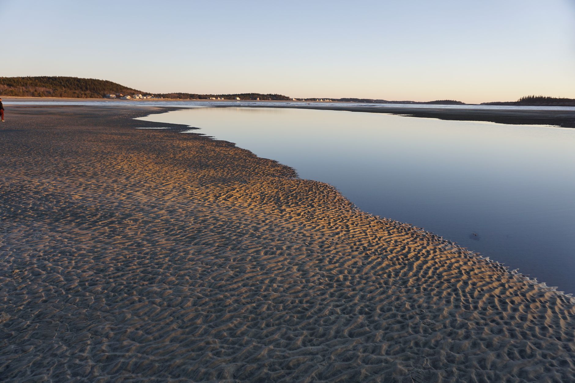 Scenic coastline at dawn with calm ocean and serene landscape, perfect for travel inspiration.
