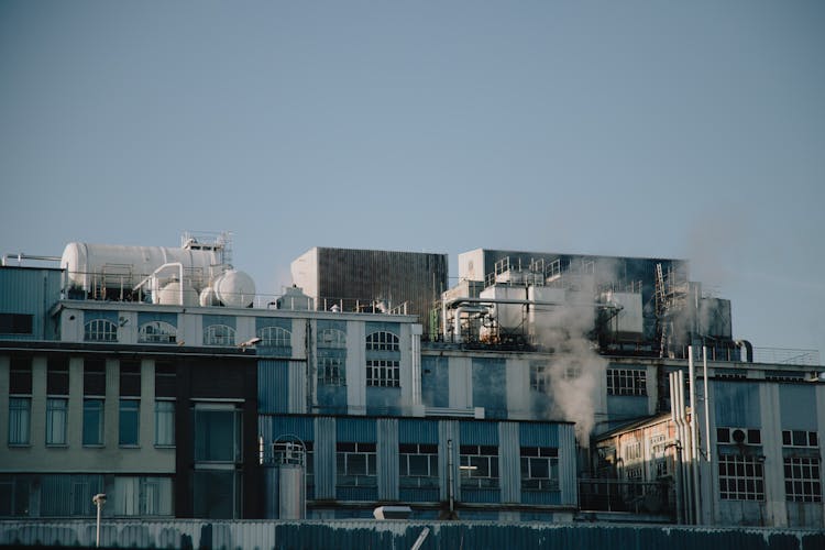 Factory Building Emitting Smoke In Industrial District