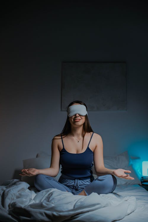 Free A Woman Meditating on the Bed  Stock Photo
