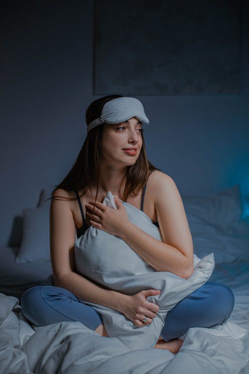 Free A Woman Hugging the Pillow Stock Photo