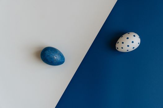 Easter eggs on a blue and white background, showcasing creative designs and contrasting colors.