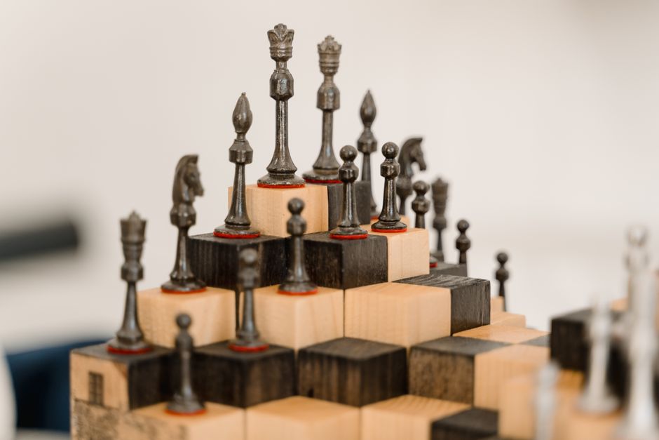 chess pieces arranged three groups board