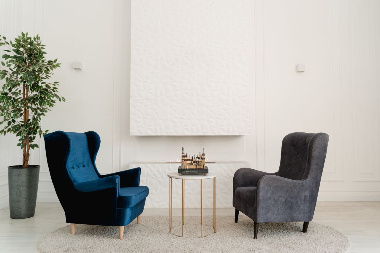 stylish room setup with blue and grey armchairs decorative plant and t
