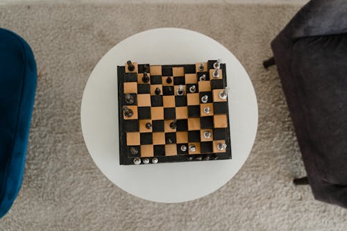 Black and Brown Chess Board on the Table