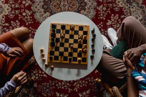 Free Overhead view of a chess game between two people seated indoors, focused on strategy. Stock Photo