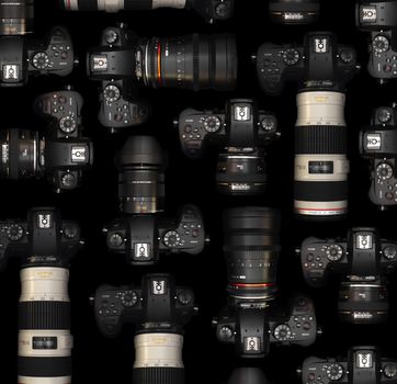 A collection of DSLR cameras and lenses against a black backdrop, showcasing modern photography equipment.