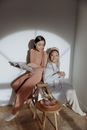 Women Sitting Back to Back while Having Conversation