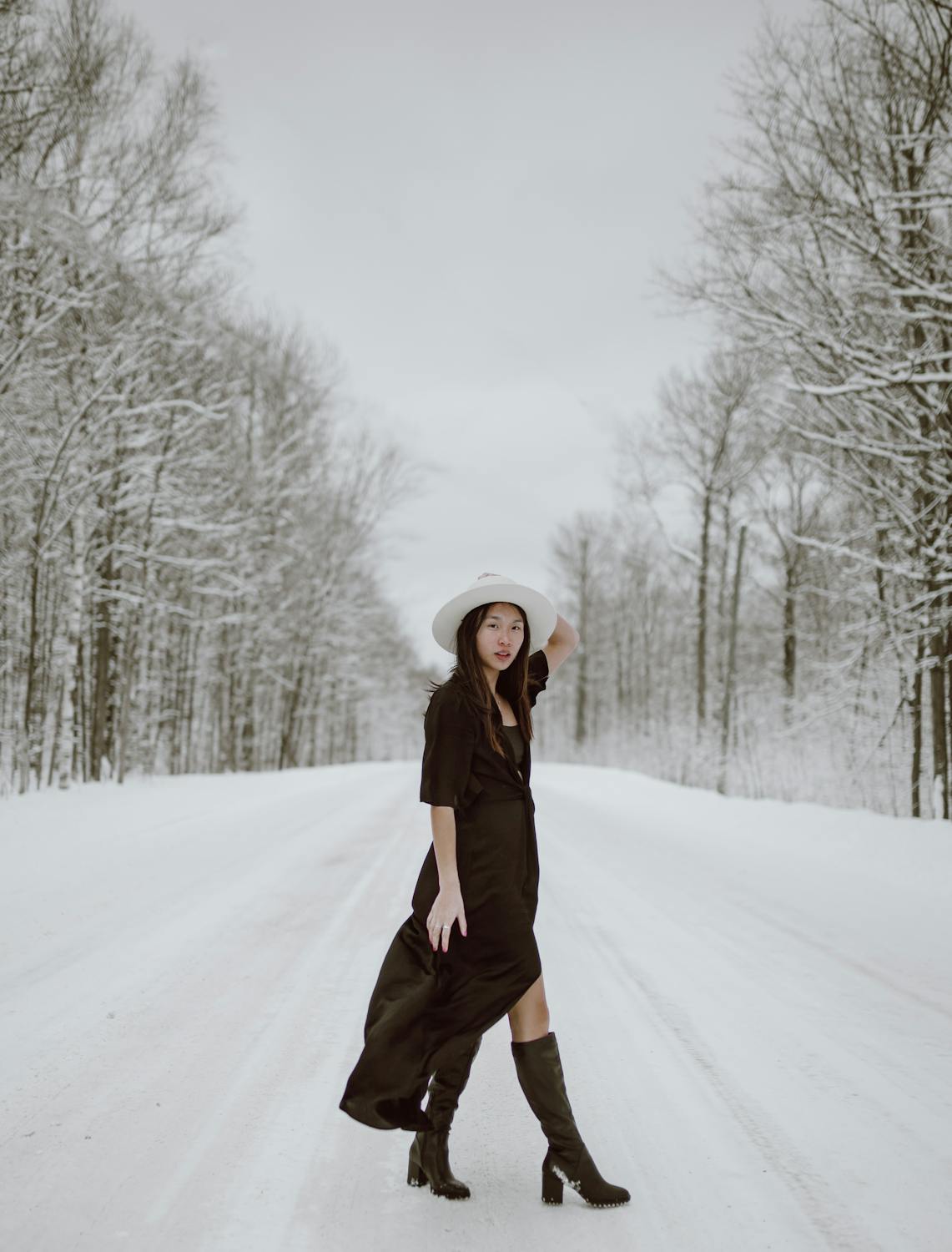 Feminine young Asian woman standing near bare trees in woods · Free ...