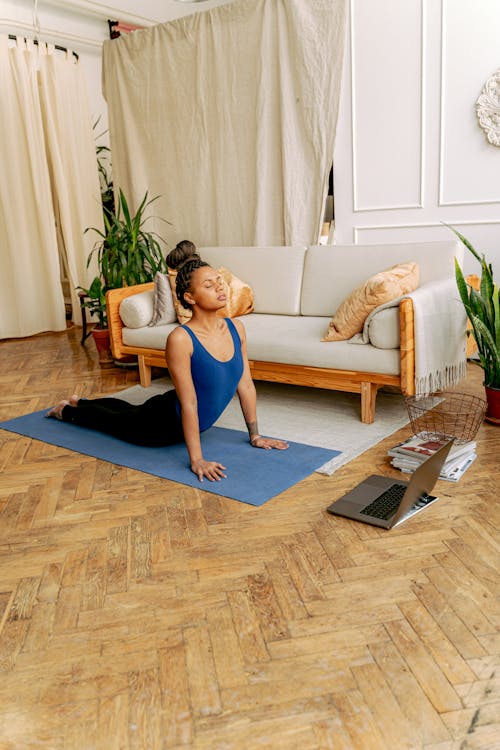 A Woman in Blue Tank Top Doing a Yoga