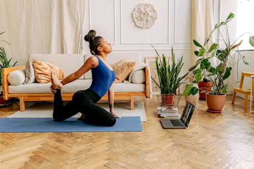 A Woman in Blue Tank Top Doing a Yoga