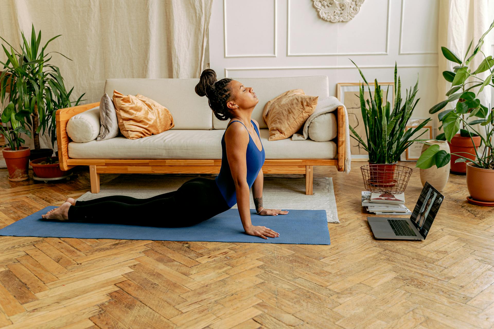 A Woman Exercising at Home with Online Coaching