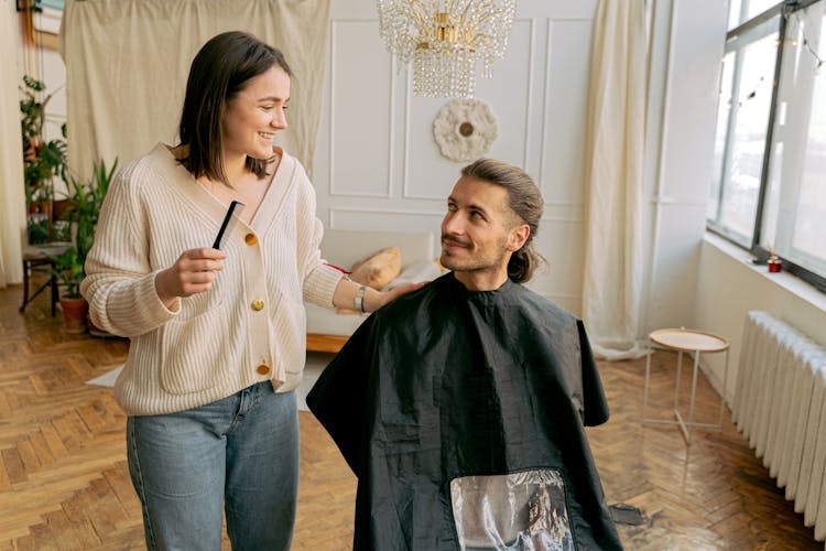 Woman Cutting Mans Hair