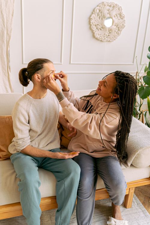 Free A couple enjoying quality time together on a comfy sofa in a bright living room. Stock Photo