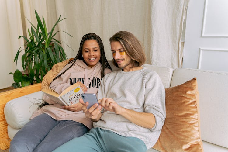 Couple Relaxing Together On Sofa