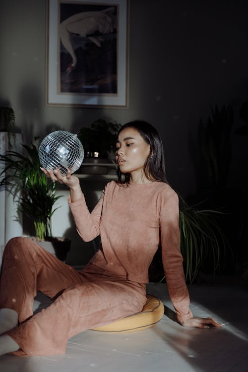 Kostnadsfri bild av asiatisk kvinna, disco boll, håller