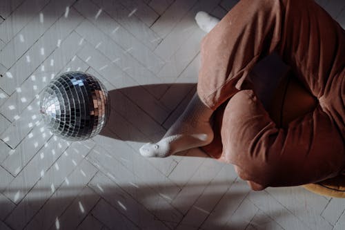 Free A Disco Ball and a Person Sitting on the Floor Stock Photo