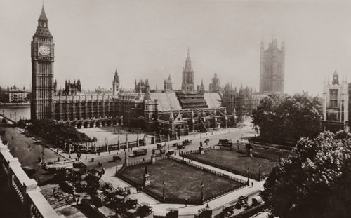 Free A historic sepia-toned photograph of Westminster Palace and Big Ben in London, England. Stock Photo
