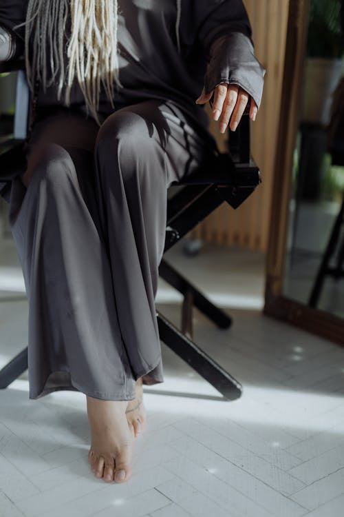 Free Woman in Gray Loungewear sitting on a Black Chair  Stock Photo