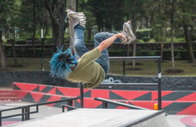 A Roller Skater Doing Flips In The Skatepark